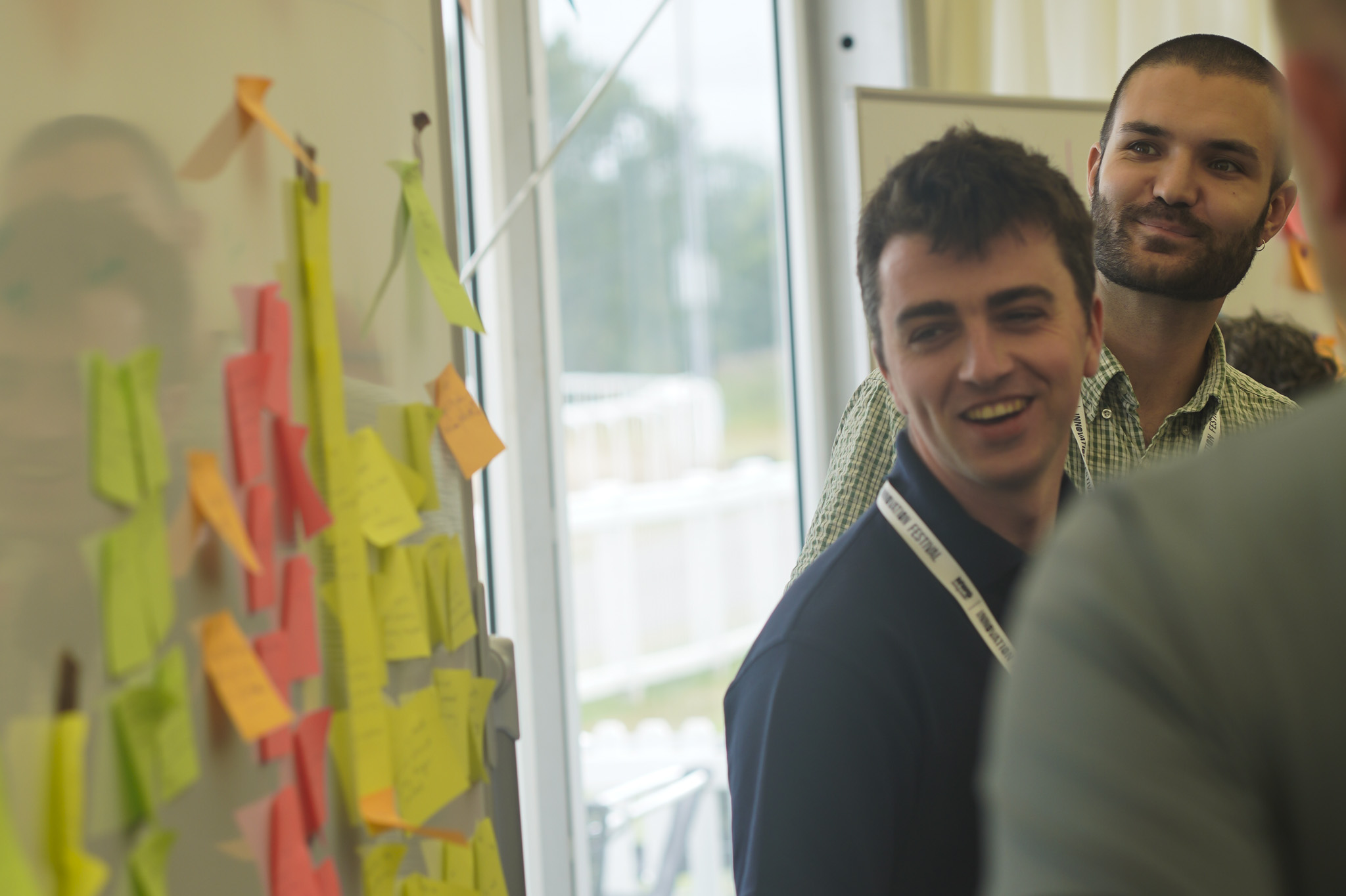 Innovation Festival 2026 - delegates around a white board with sticky notes
