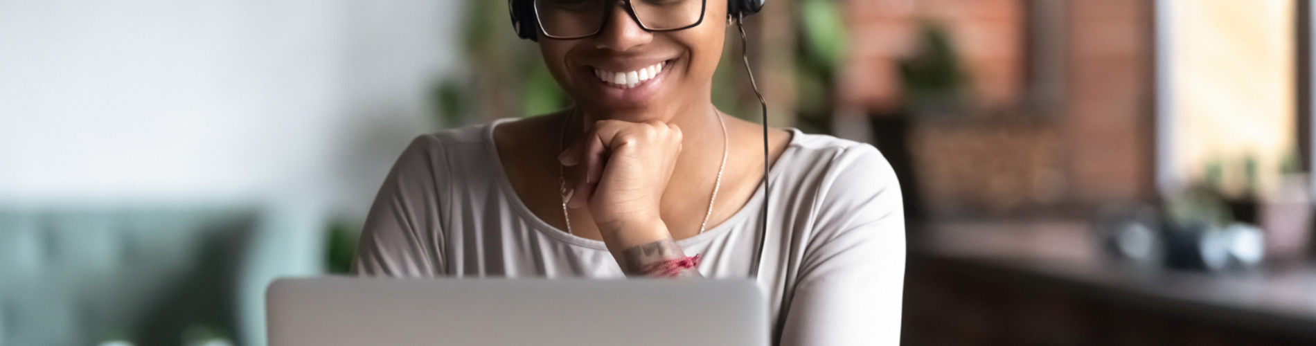 woman using laptop wearing headset 